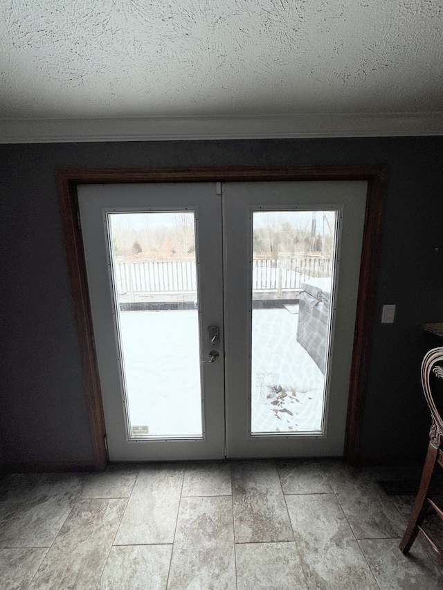 doorway with ornamental molding, a wealth of natural light, and french doors