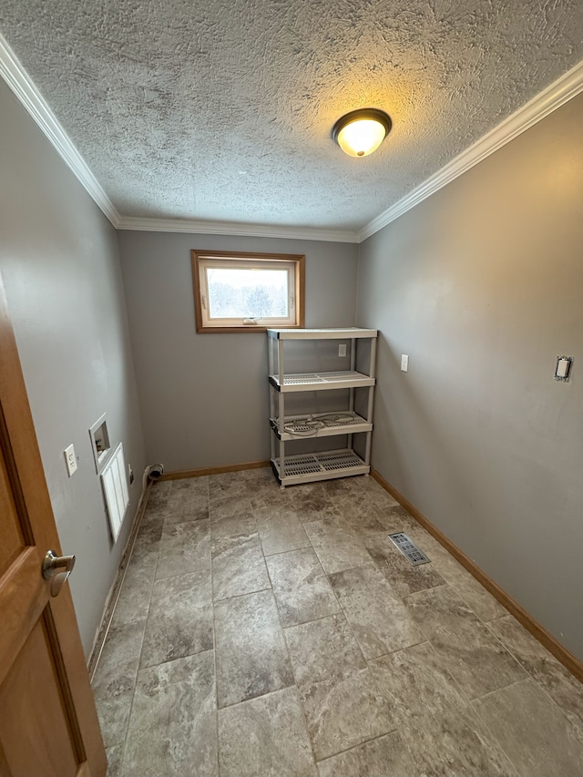 spare room featuring ornamental molding, visible vents, a textured ceiling, and baseboards