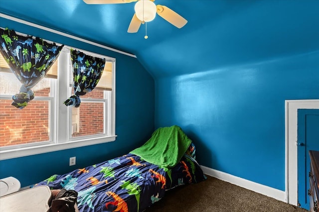 unfurnished bedroom featuring vaulted ceiling, carpet floors, a ceiling fan, and baseboards