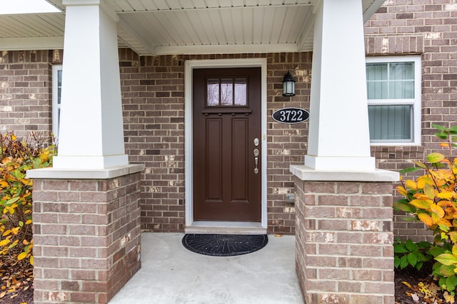 property entrance featuring brick siding