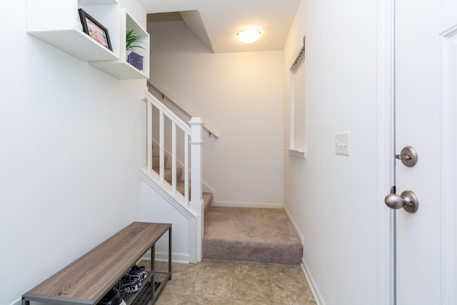 stairs with carpet floors and baseboards