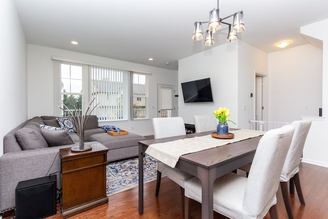 dining area with a chandelier, baseboards, wood finished floors, and recessed lighting