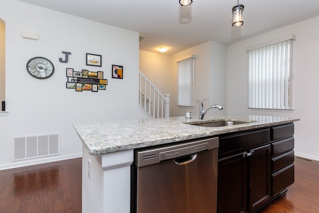 kitchen with a sink, visible vents, dark wood-style floors, dishwasher, and an island with sink