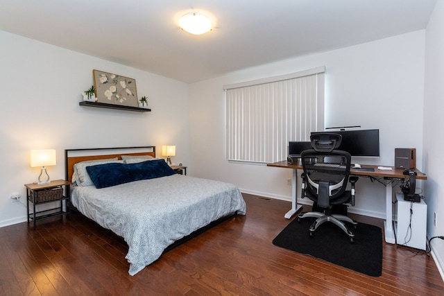 bedroom featuring dark wood-style flooring and baseboards