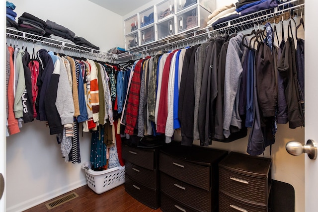 spacious closet featuring dark wood finished floors and visible vents