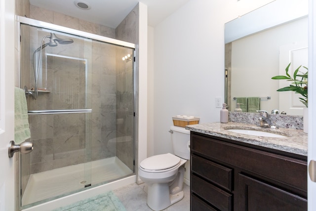 bathroom featuring a stall shower, vanity, and toilet