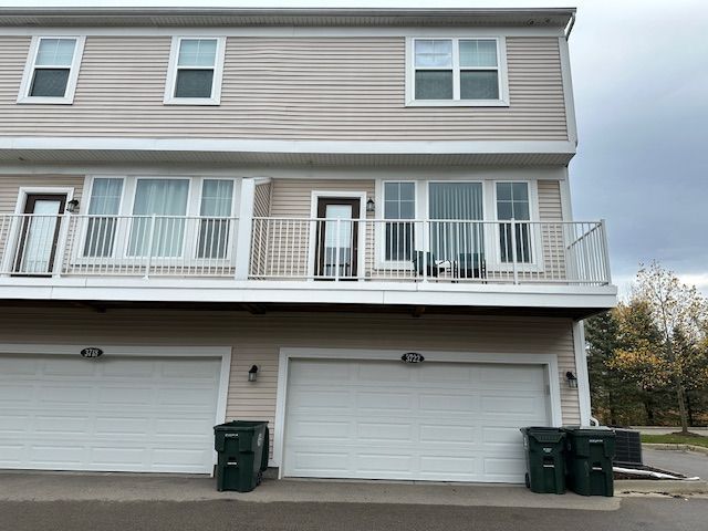 rear view of house featuring an attached garage