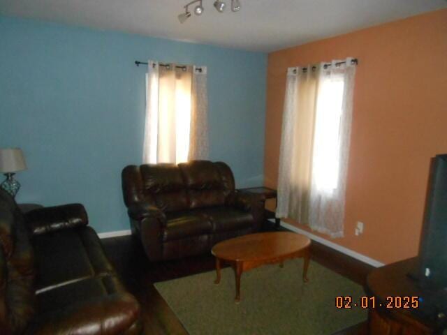 living area featuring baseboards