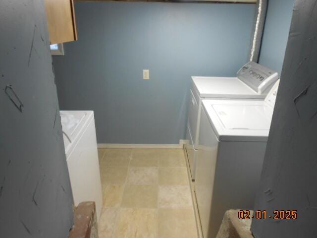 laundry area with washing machine and dryer, laundry area, and baseboards