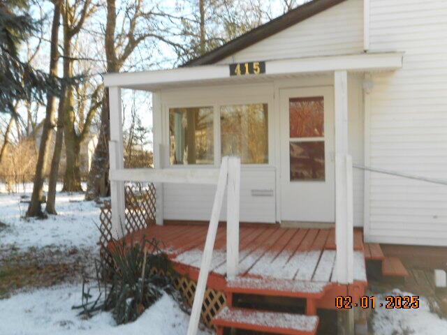 view of snow covered property entrance