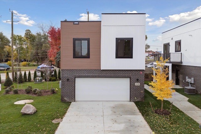 view of front of home with a garage, central AC, brick siding, driveway, and a front yard