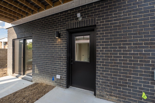 entrance to property with brick siding