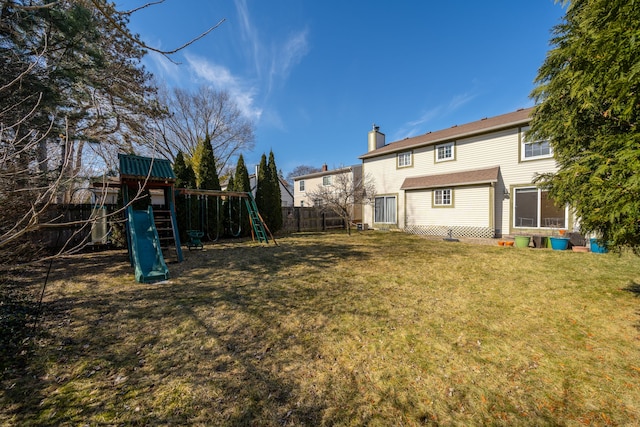 view of yard with fence and a playground