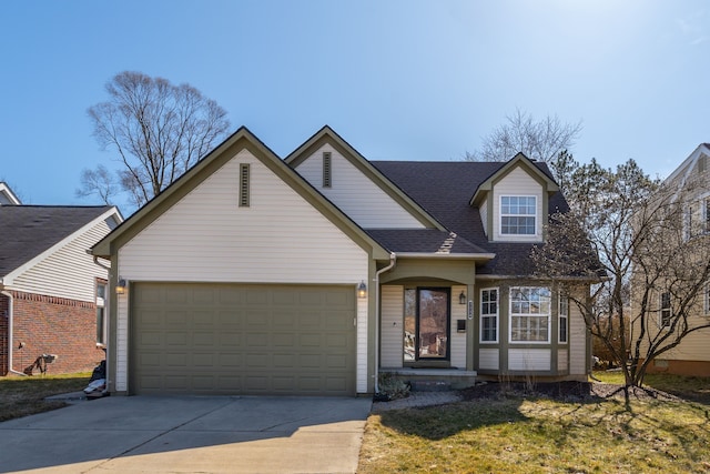 traditional-style house featuring a garage, roof with shingles, and driveway