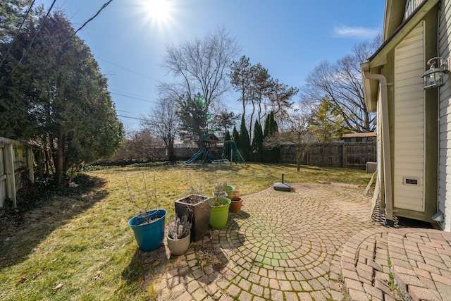 view of patio / terrace with a fenced backyard and a playground