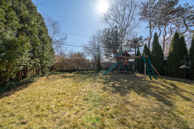 view of yard with a playground and a fenced backyard