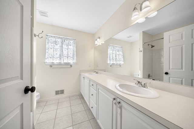 bathroom featuring toilet, visible vents, and a sink