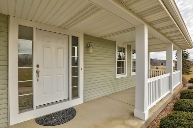 view of exterior entry with a porch