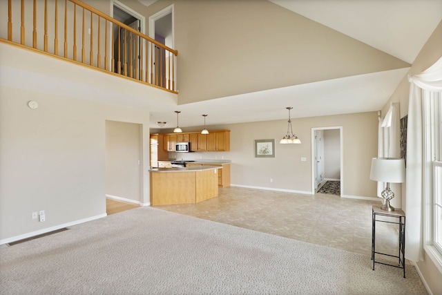 unfurnished living room with light tile patterned floors, light colored carpet, visible vents, high vaulted ceiling, and baseboards