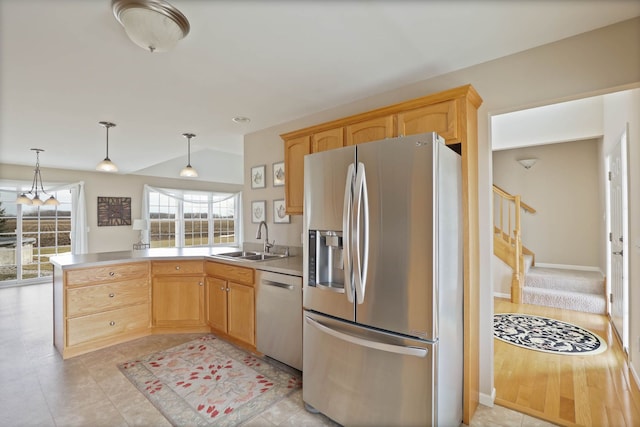 kitchen with dishwashing machine, a peninsula, a sink, vaulted ceiling, and stainless steel fridge with ice dispenser