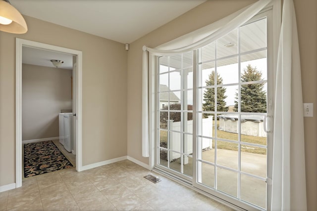 entryway featuring separate washer and dryer, visible vents, and baseboards