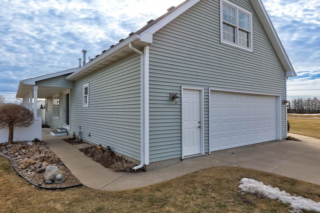 view of property exterior featuring driveway and an attached garage