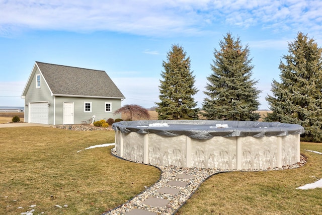 exterior space featuring an outbuilding, a covered pool, and a lawn