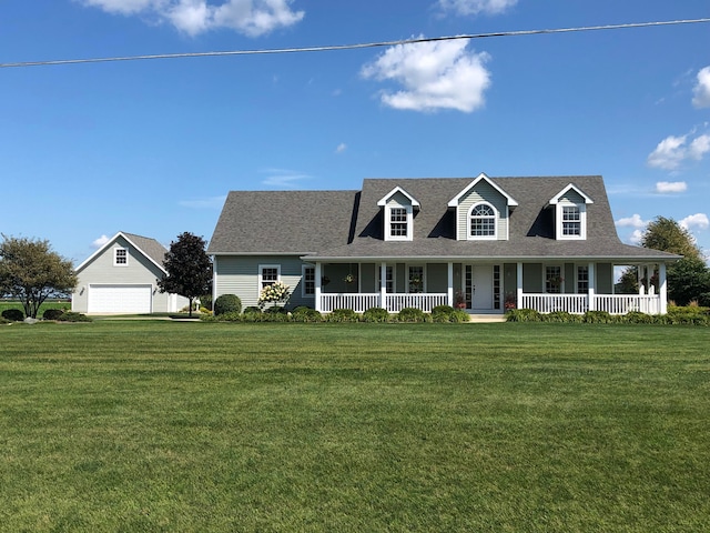 new england style home featuring a porch, roof with shingles, and a front yard