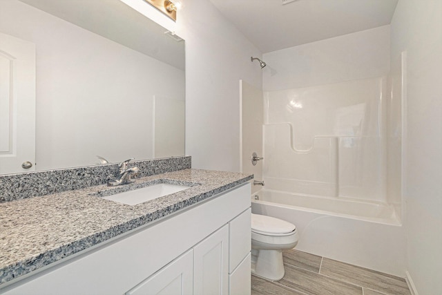 full bath with toilet, shower / bathing tub combination, wood finish floors, and vanity