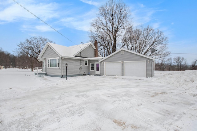 view of front of property featuring a chimney and an attached garage