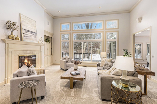 living area featuring plenty of natural light, light colored carpet, and a fireplace