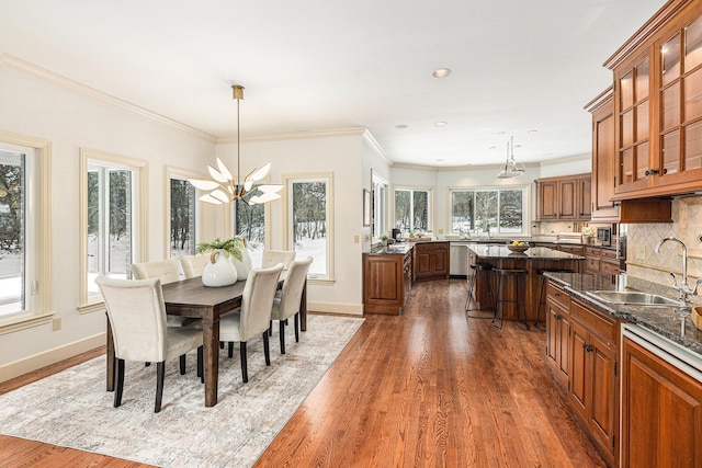 dining room with baseboards, dark wood finished floors, and a chandelier