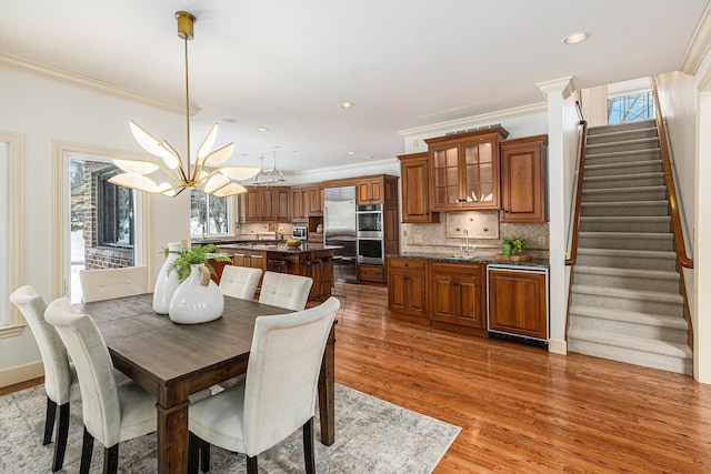 dining room with stairs, dark wood-type flooring, and a healthy amount of sunlight