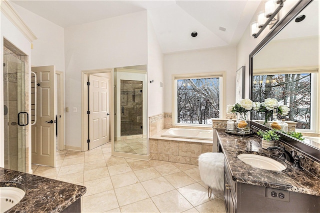 full bath with a garden tub, vanity, vaulted ceiling, a shower stall, and tile patterned floors