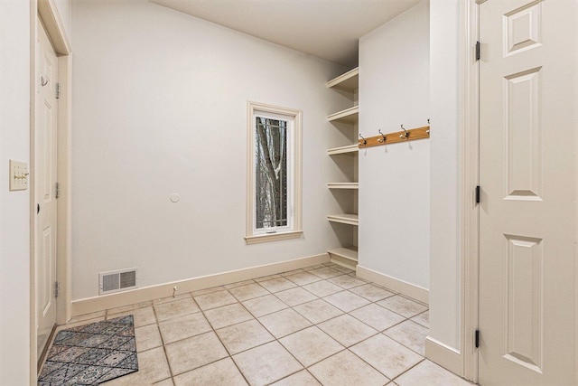 mudroom with light tile patterned floors, visible vents, and baseboards