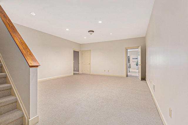 unfurnished room featuring baseboards, stairway, recessed lighting, and light colored carpet