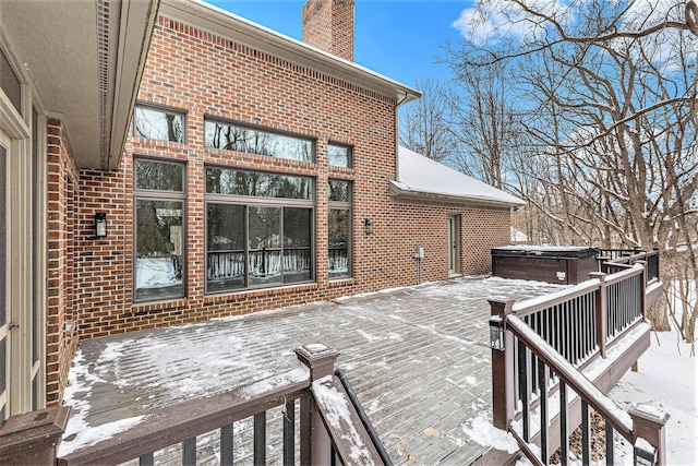 snow covered deck featuring a hot tub