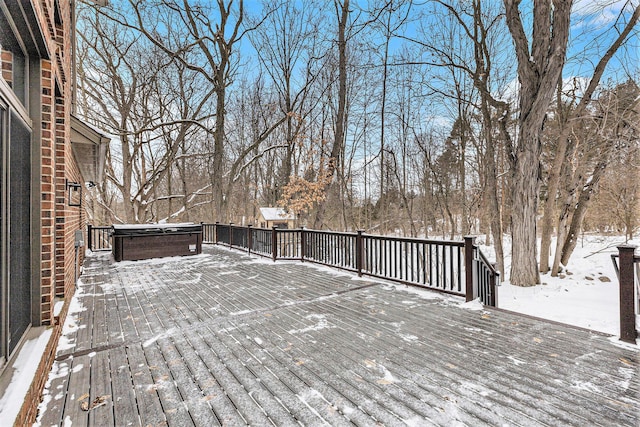 snow covered deck featuring a hot tub