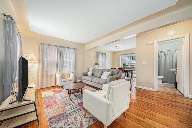 living room featuring light wood-type flooring and baseboards