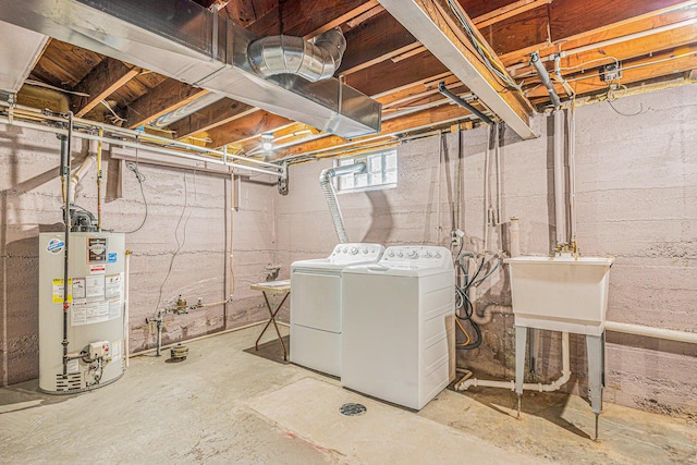 below grade area featuring washing machine and dryer, water heater, and a sink