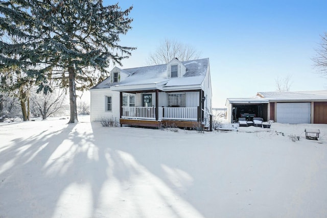 view of front of home with a porch and a detached garage