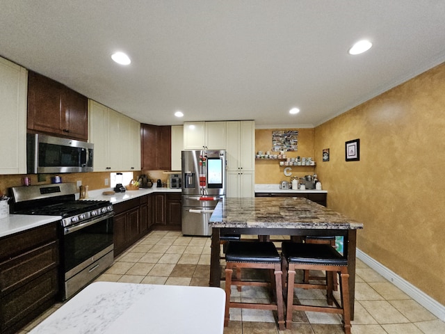 kitchen with stainless steel appliances, light countertops, dark brown cabinetry, and recessed lighting