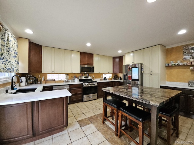 45 Forthton Dr, Troy, MI 48084 - kitchen featuring stainless steel appliances, light countertops, light tile patterned floors, recessed lighting, and dark brown cabinets
