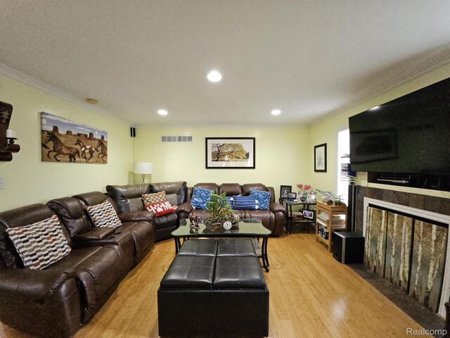 45 Forthton Dr, Troy, MI 48084 - living area with ornamental molding, light wood-style floors, a fireplace with flush hearth, and recessed lighting