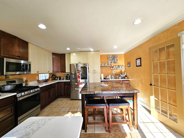 kitchen with dark brown cabinetry, ornamental molding, light tile patterned flooring, stainless steel appliances, and recessed lighting