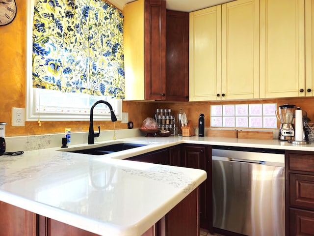 kitchen featuring decorative backsplash, a peninsula, light countertops, stainless steel dishwasher, and a sink