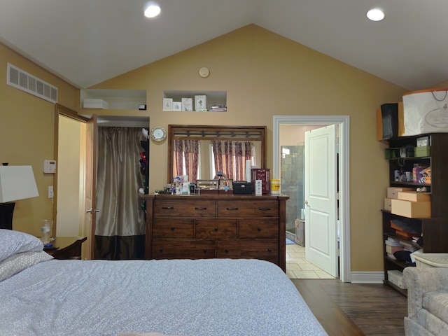 bedroom featuring visible vents, connected bathroom, lofted ceiling, wood finished floors, and recessed lighting