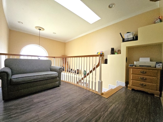 living area featuring vaulted ceiling with skylight, dark wood-style flooring, an upstairs landing, baseboards, and ornamental molding