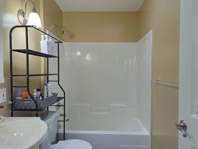 bathroom with shower / bath combination, a sink, and toilet