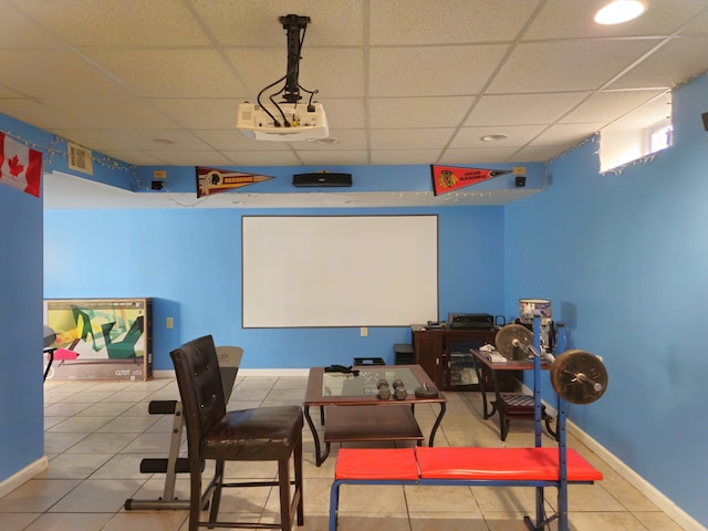 tiled cinema room with a paneled ceiling, visible vents, and baseboards